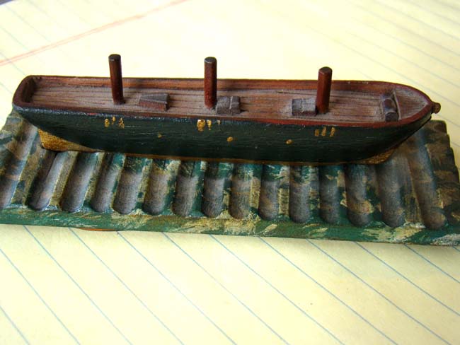 A charming miniature 19th century carved wooden sailing ship at drydock, the underside of base with five whaling log book stamps. — image 3